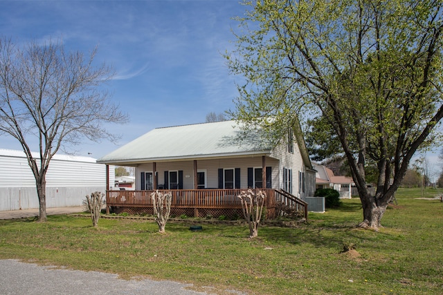 view of front of home with a front yard and a deck