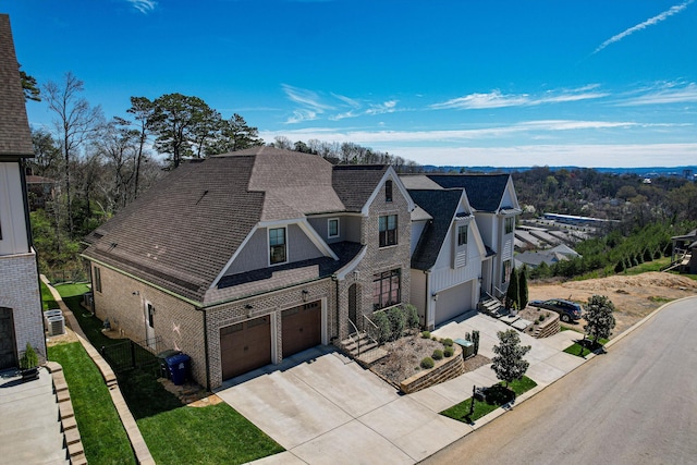 view of front of house featuring a garage and central AC