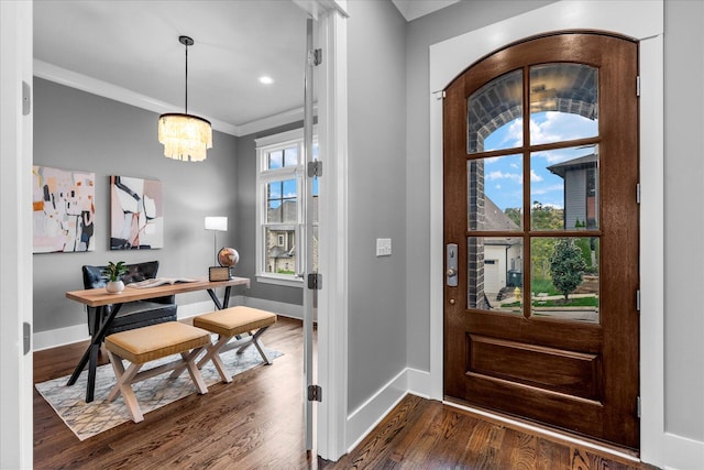 foyer with dark hardwood / wood-style floors, plenty of natural light, crown molding, and a notable chandelier