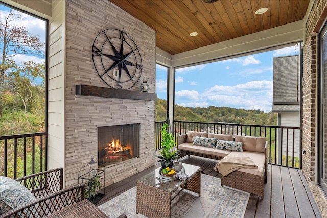 deck featuring an outdoor living space with a fireplace