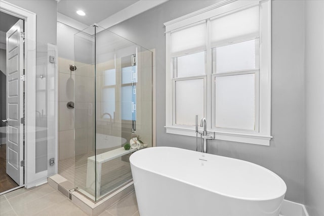 bathroom featuring plus walk in shower and tile patterned floors