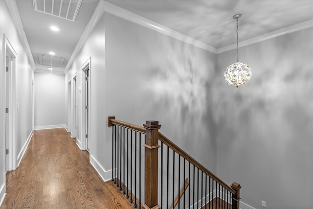 hall featuring wood-type flooring and ornamental molding