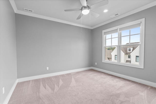 carpeted empty room with ceiling fan and ornamental molding