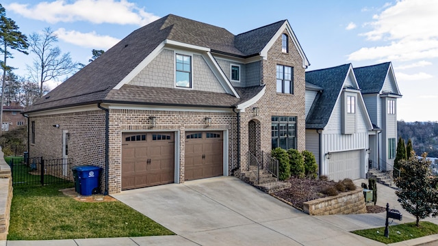 view of front of home featuring a garage, driveway, brick siding, and a shingled roof