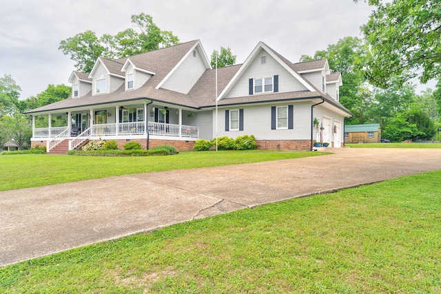 view of front of property featuring a porch, a garage, and a front lawn