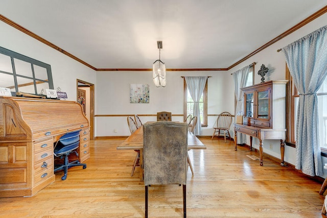 dining space with light wood-type flooring and crown molding