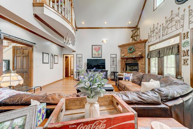 living room featuring hardwood / wood-style flooring, ornamental molding, and high vaulted ceiling