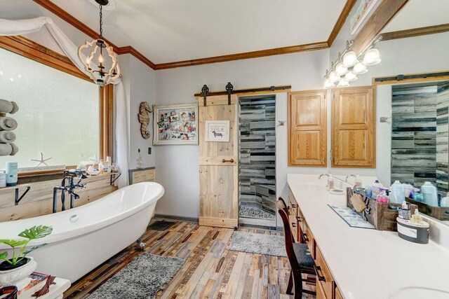 bathroom with ornamental molding, vanity, separate shower and tub, a chandelier, and hardwood / wood-style floors