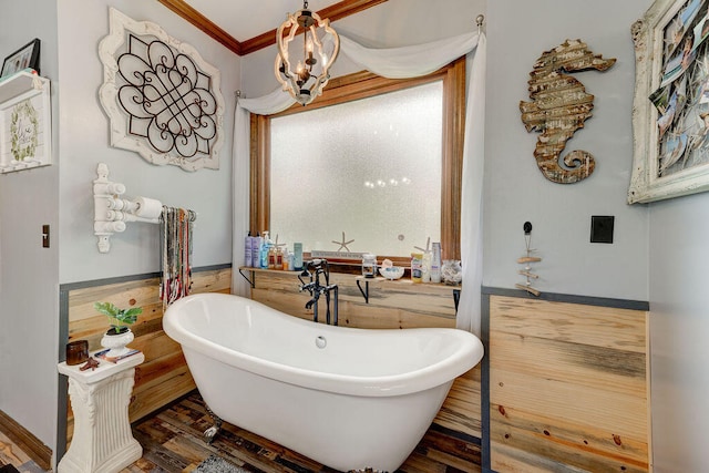 bathroom featuring a chandelier, crown molding, a washtub, and hardwood / wood-style floors