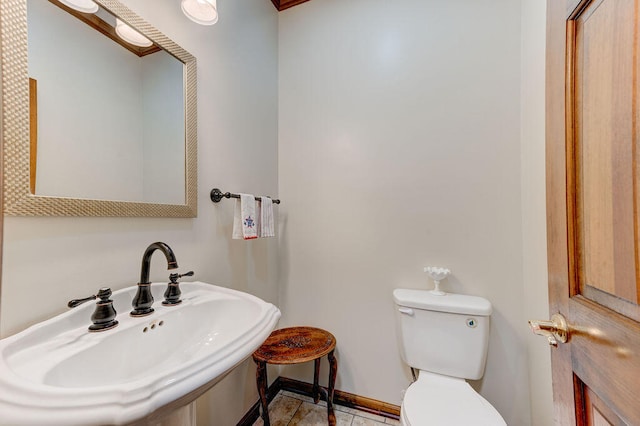 bathroom with tile patterned flooring, toilet, and sink