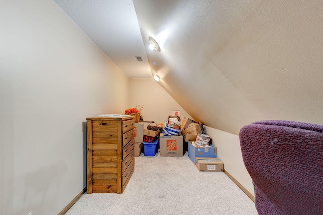 bonus room with carpet flooring and vaulted ceiling