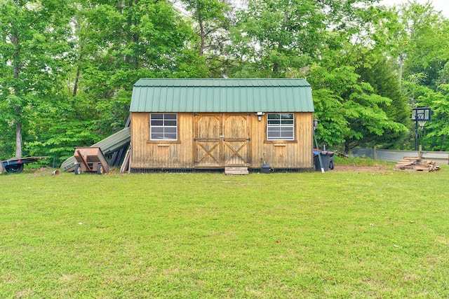 view of outdoor structure featuring a lawn