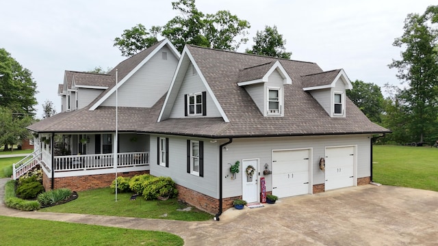 view of front of property with a front lawn, a porch, and a garage