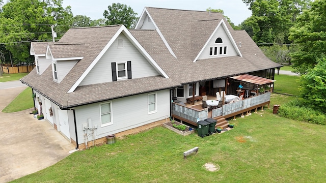 rear view of house with a yard and a wooden deck