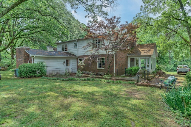 rear view of house with a yard