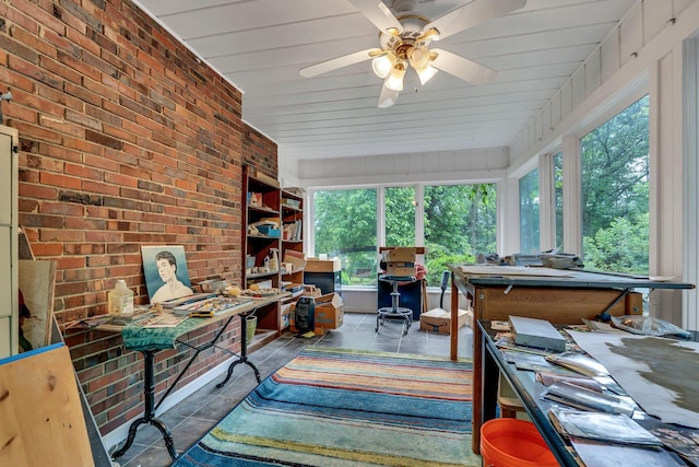 sunroom / solarium with a healthy amount of sunlight and ceiling fan