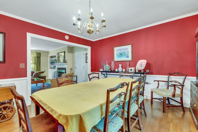 dining area with ornamental molding and hardwood / wood-style floors