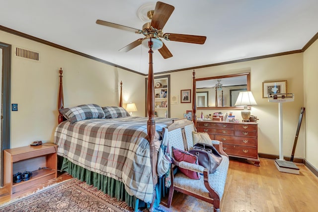 bedroom featuring hardwood / wood-style floors, ceiling fan, and crown molding