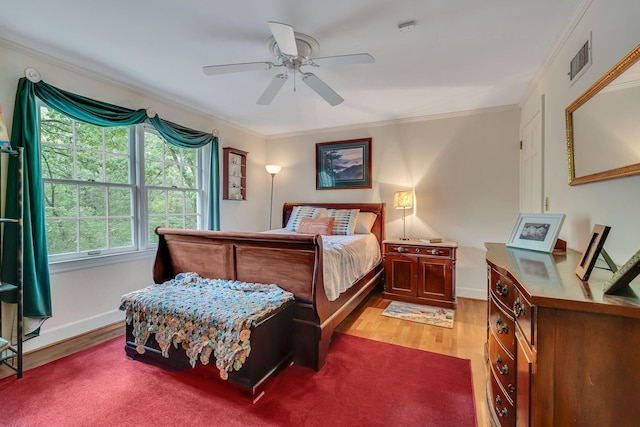 bedroom featuring ornamental molding, hardwood / wood-style floors, and ceiling fan