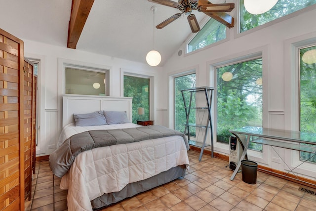 tiled bedroom featuring ceiling fan and vaulted ceiling with beams