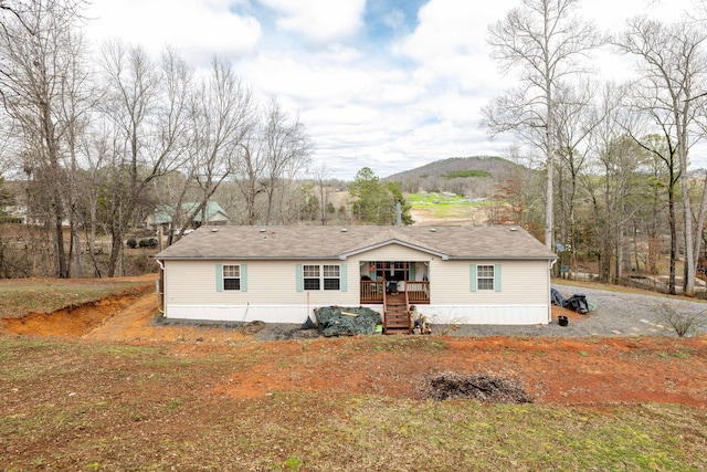 view of front of home featuring covered porch and a mountain view