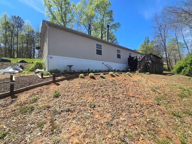 view of side of property with a wooden deck