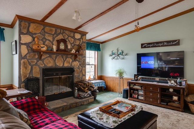 living room with lofted ceiling, a fireplace, a textured ceiling, and wood walls