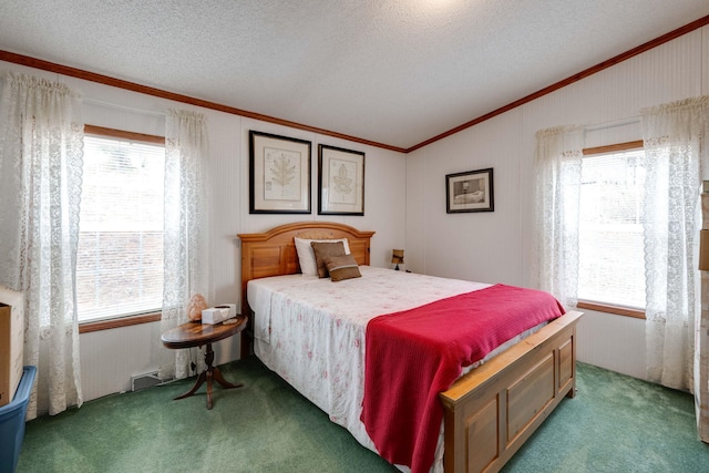 bedroom with a textured ceiling, multiple windows, and carpet