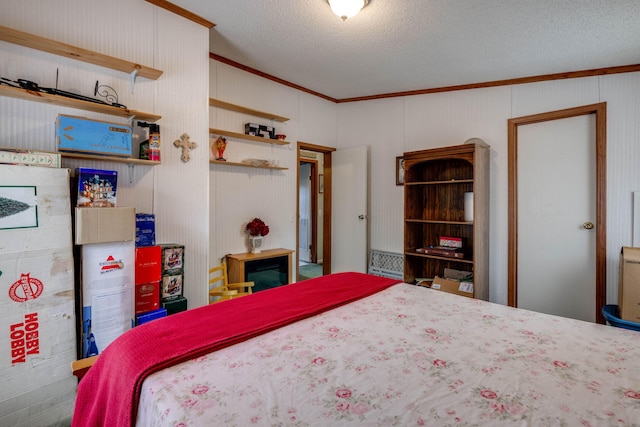 bedroom with a textured ceiling and crown molding