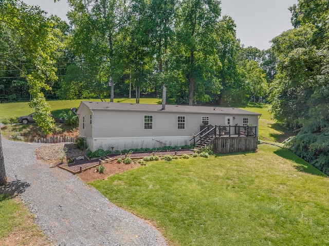 back of house featuring a deck and a lawn