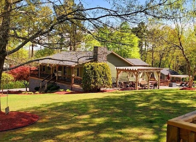 rear view of house with a pergola and a yard