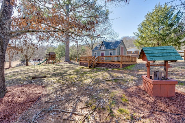 view of yard featuring a playground and a deck