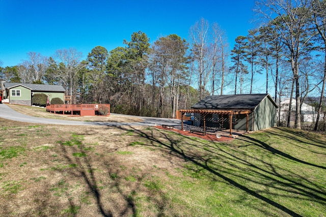 view of yard with an outdoor structure and a wooden deck