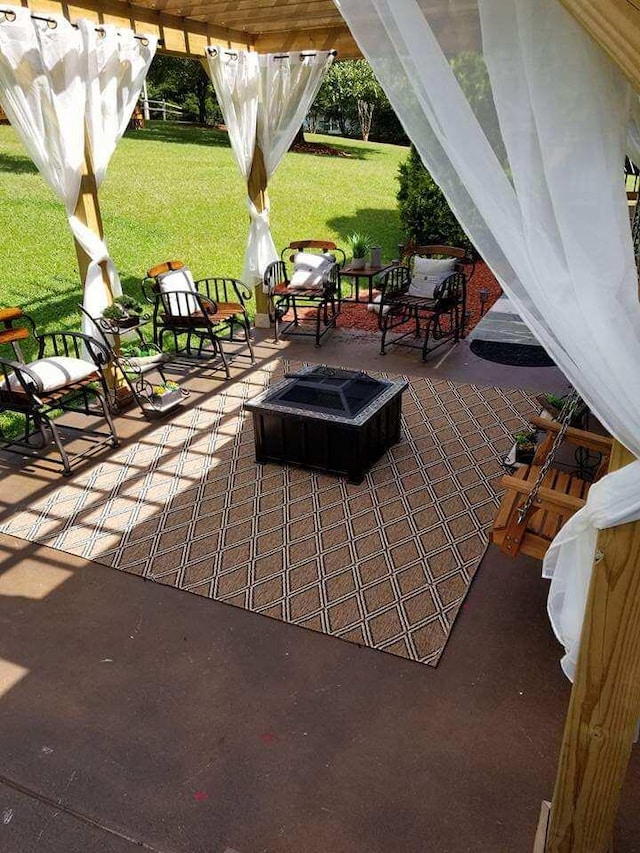 view of patio / terrace featuring an outdoor fire pit