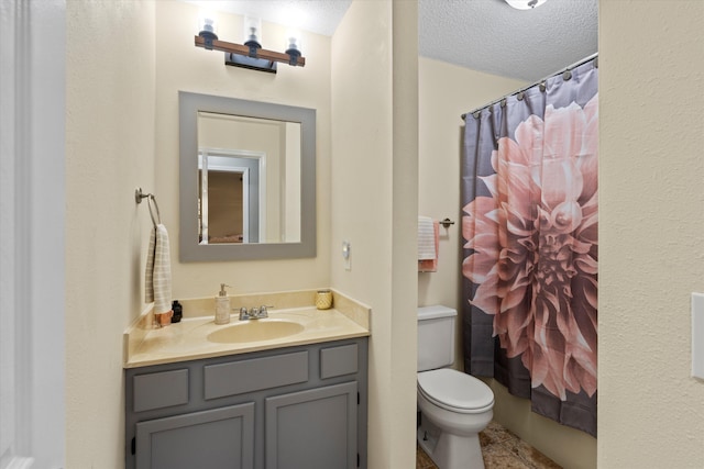 bathroom featuring a shower with shower curtain, tile patterned floors, toilet, vanity, and a textured ceiling