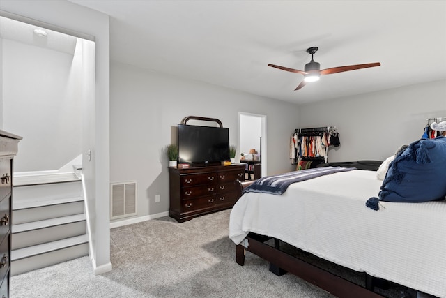 bedroom featuring ceiling fan and light carpet