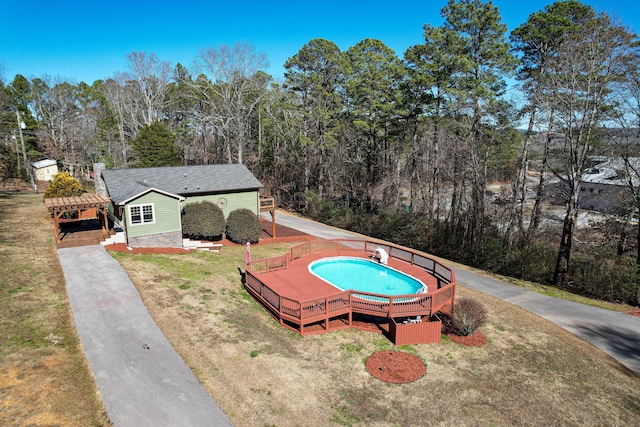 exterior space featuring a deck and a front lawn