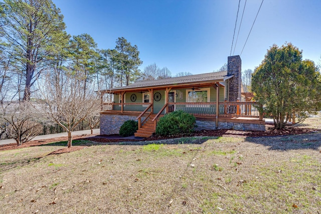 view of front of property with a front yard and a porch