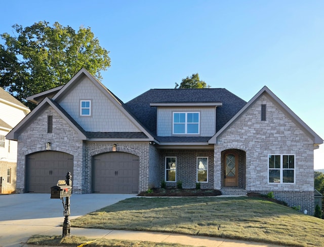 view of front of house with a garage and a front lawn