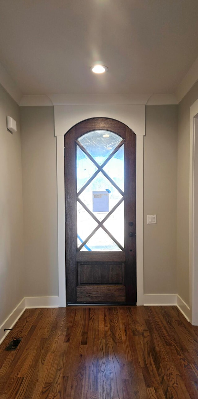 foyer featuring dark hardwood / wood-style flooring and ornamental molding