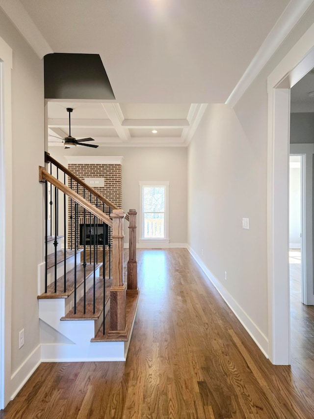 interior space featuring ceiling fan, beamed ceiling, coffered ceiling, and hardwood / wood-style flooring