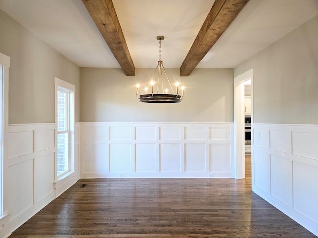 unfurnished dining area featuring beam ceiling, dark hardwood / wood-style floors, and a notable chandelier