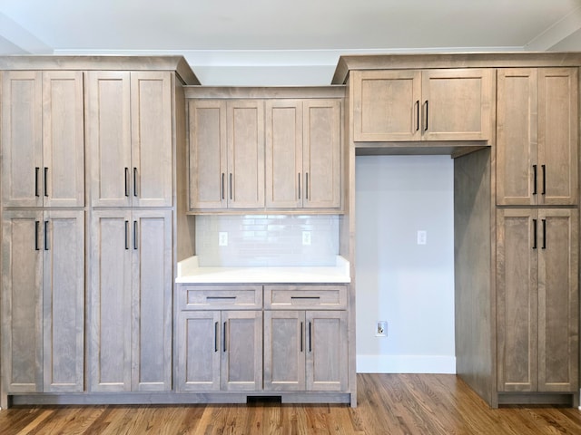 kitchen with dark hardwood / wood-style floors and decorative backsplash