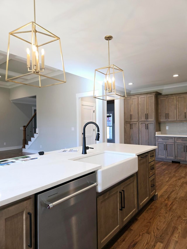 kitchen with decorative backsplash, stainless steel dishwasher, sink, dark hardwood / wood-style floors, and hanging light fixtures