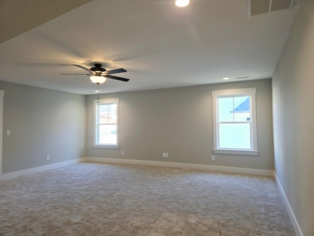 spare room featuring ceiling fan and light carpet