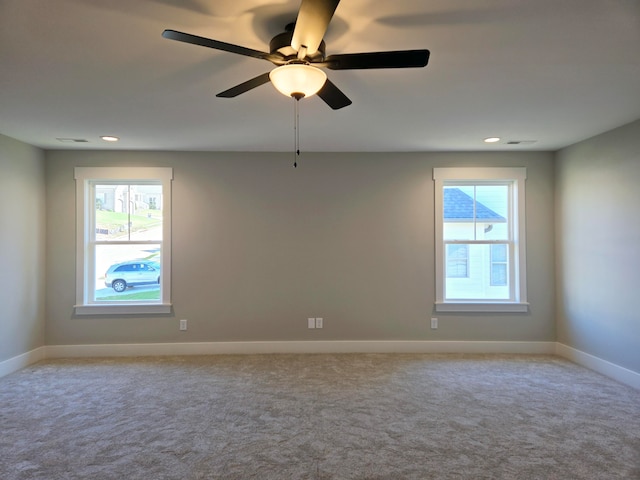 carpeted spare room with ceiling fan and a healthy amount of sunlight