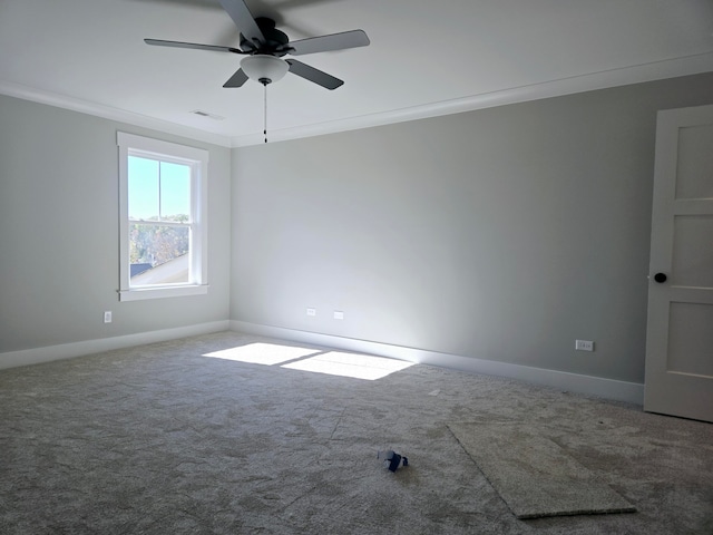 empty room with carpet flooring, ceiling fan, and ornamental molding