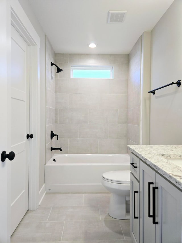 full bathroom featuring toilet, tile patterned flooring, vanity, and tiled shower / bath