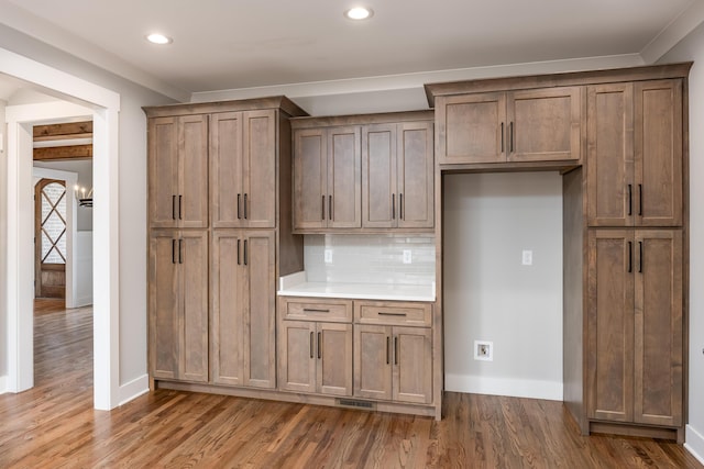 kitchen featuring recessed lighting, baseboards, tasteful backsplash, and wood finished floors