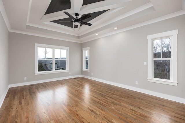 unfurnished room with wood finished floors, baseboards, and ornamental molding